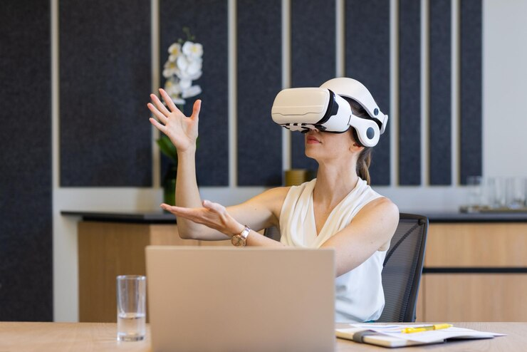 A futuristic office scene where humans and autonomous AI agents collaborate seamlessly—digital assistants handle data tasks, chatbots manage customer service, and virtual agents support project management. The image reflects how autonomous agents are transforming the workplace by enhancing productivity, enabling remote operations, and redefining traditional job roles.